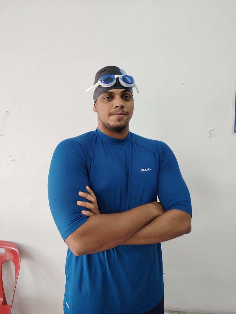 Coach Sachin, adult and stroke coach, poolside in his swim cap and goggles