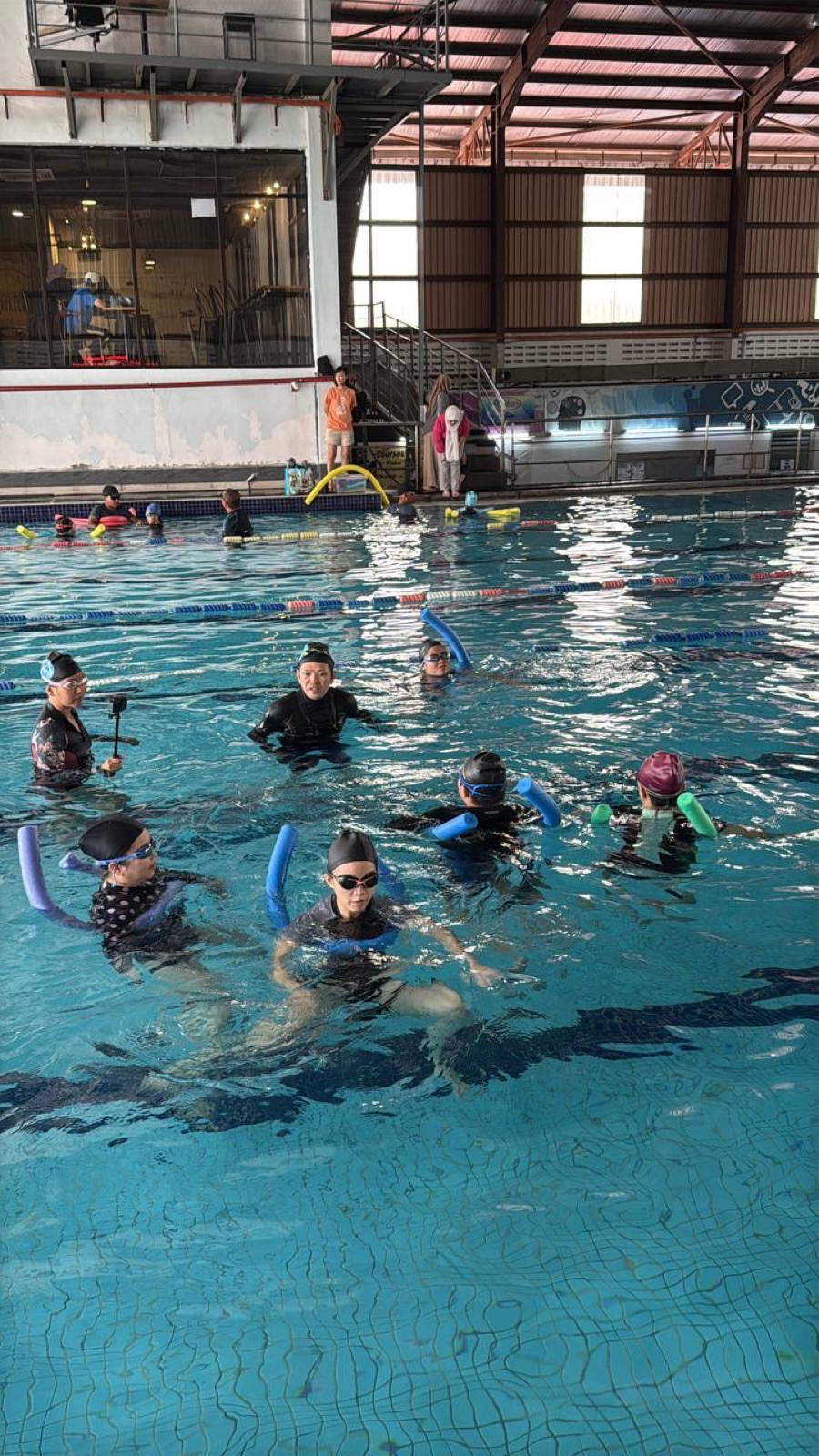 Swimmers practising in a larger pool